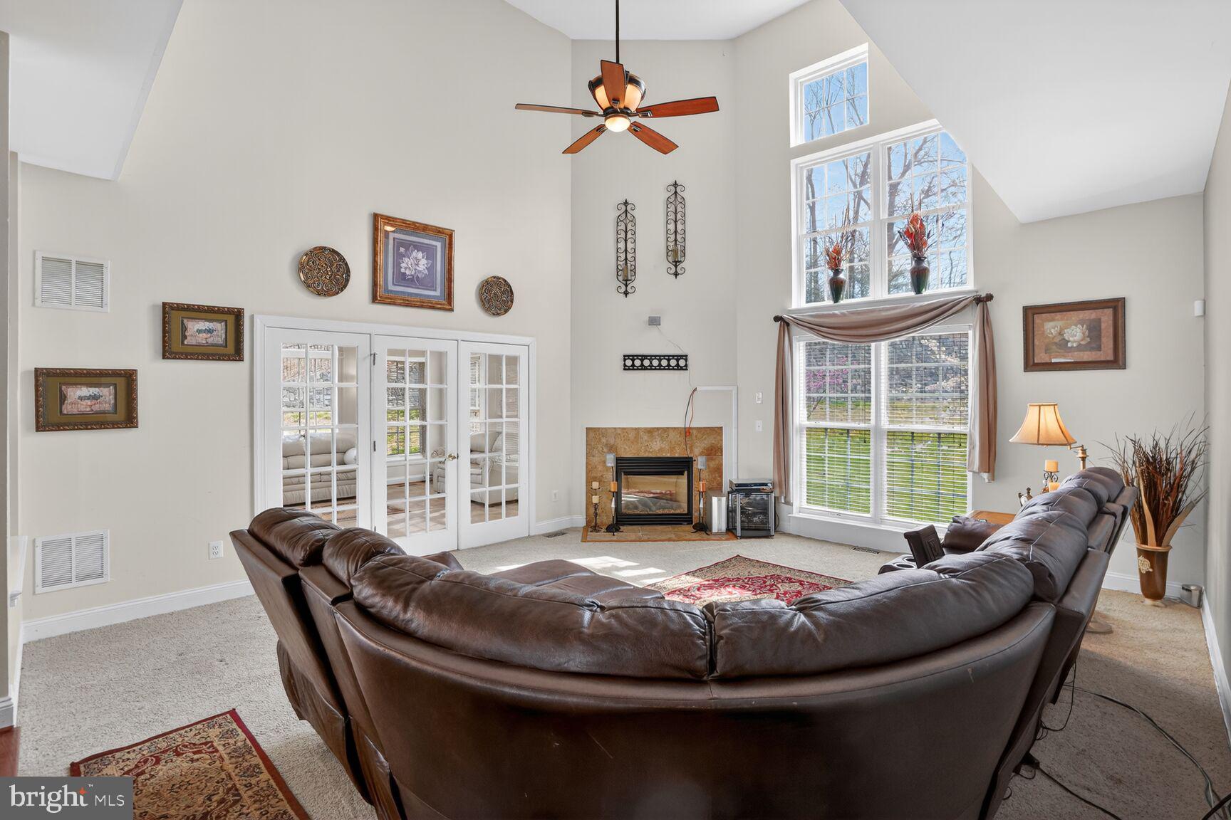 3308 McCorkle Court Triangle, VA 22172 - Photo 30 of 82 a living room with furniture a fireplace and a floor to ceiling window