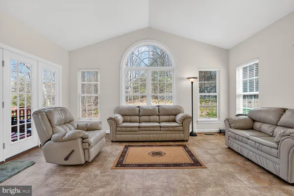a bedroom with furniture and a large mirror