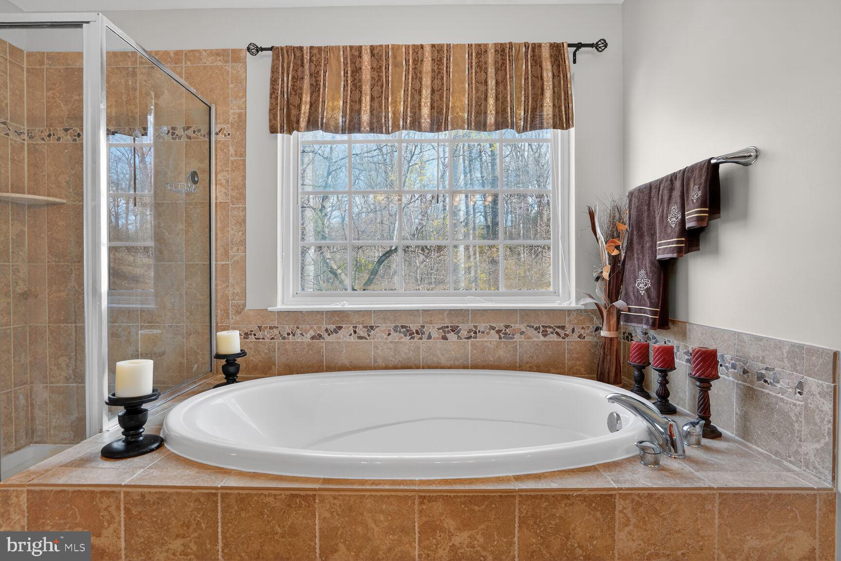 3308 McCorkle Court Triangle, VA 22172 - Photo 41 of 82 a white bath tub sitting next to a bathroom sink