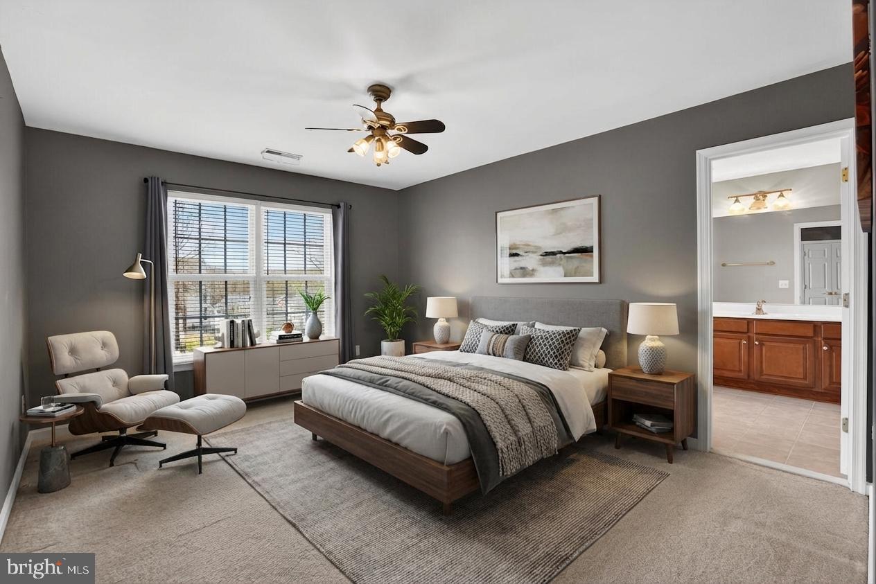 3308 McCorkle Court Triangle, VA 22172 - Photo 44 of 82 a spacious bedroom with a bed a couch and a window