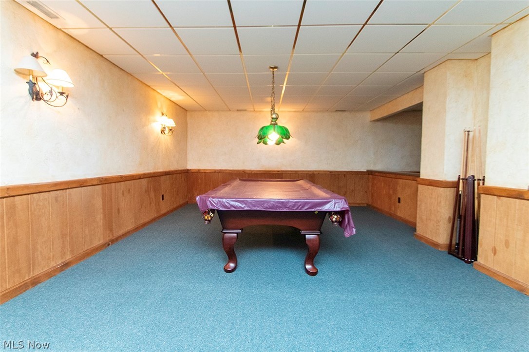 1871 Mattingly Road Hinckley, OH 44233 - Photo 38 of 50 Recreation room featuring a drop ceiling, wooden walls, billiards table, carpet flooring, and a wainscoted wall
