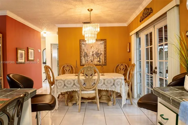 a dining room with furniture and chandelier