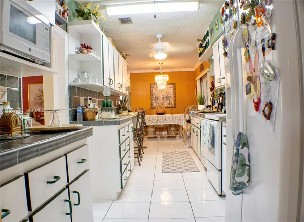 a kitchen with stainless steel appliances kitchen island granite countertop a sink and cabinets