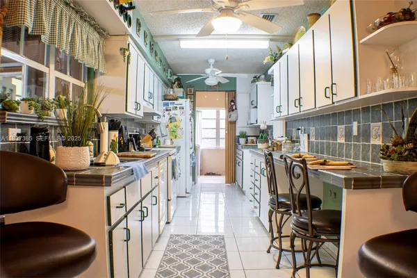 a kitchen with stainless steel appliances granite countertop a stove and cabinets