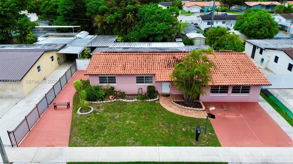 a view of a backyard with plants and patio
