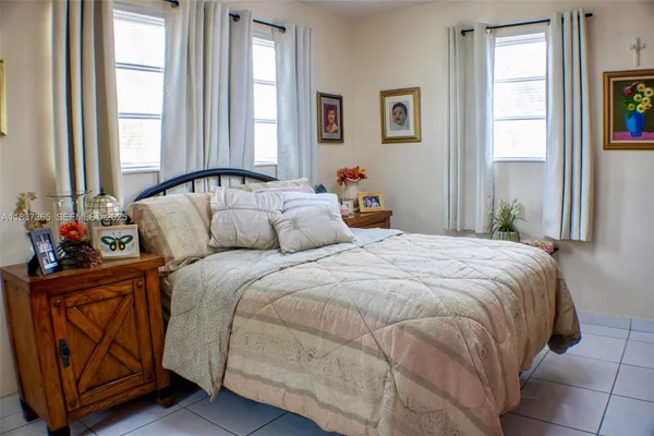 a bedroom with bed and window