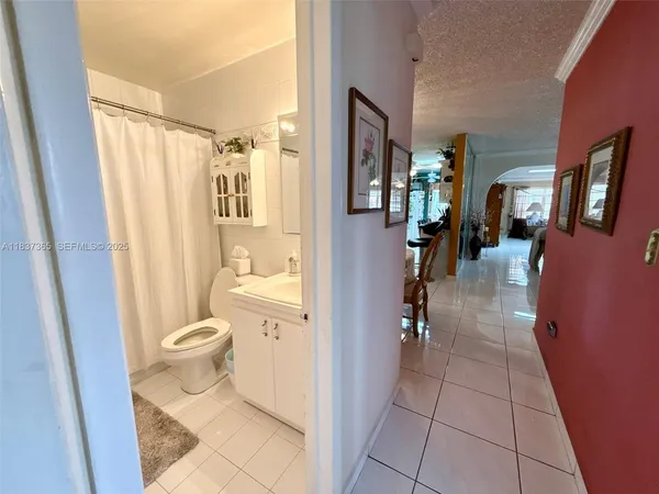 a bathroom with a toilet a sink and shower