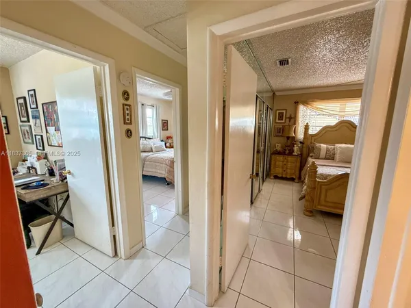 a view of a hallway with living room and dining room view