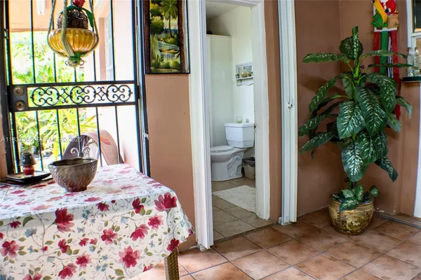 a bedroom with a bed and a potted plant