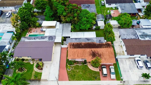 an aerial view of multiple houses with yard