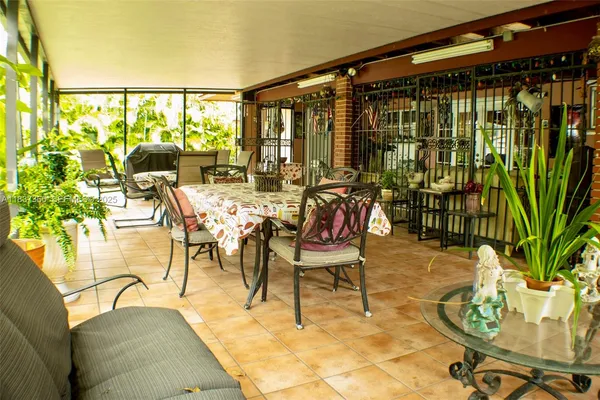 a dining room with furniture and floor to ceiling window