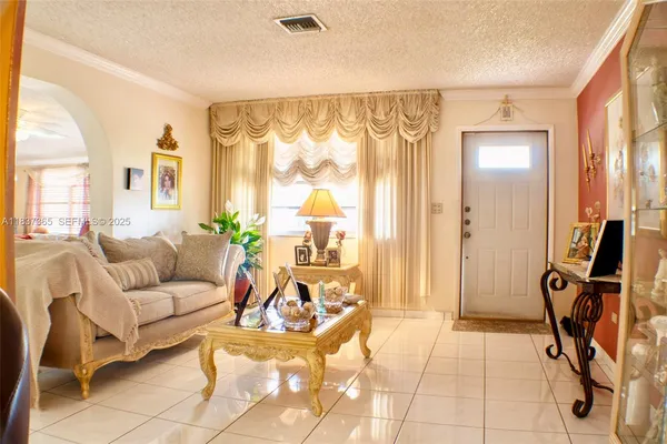a living room with furniture a dining table and a large window