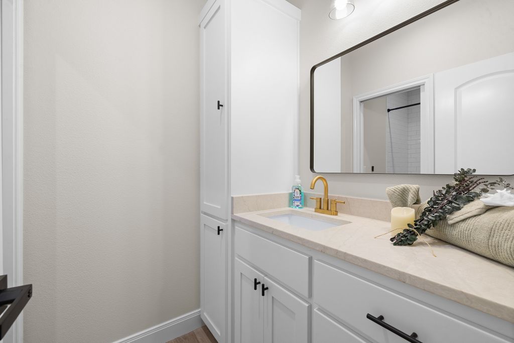 1703 County Road, Unit 217 Giddings, TX 78942 - Photo 14 of 19 A tailored vanity area integrates seamless built-in storage cabinets alongside sleek stone countertops.