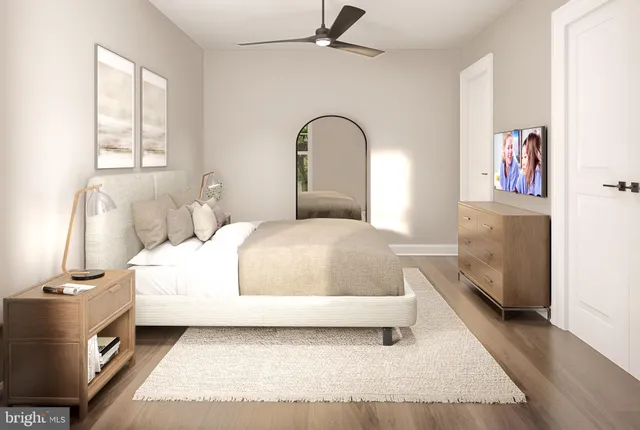 a bedroom with a bed and a large window