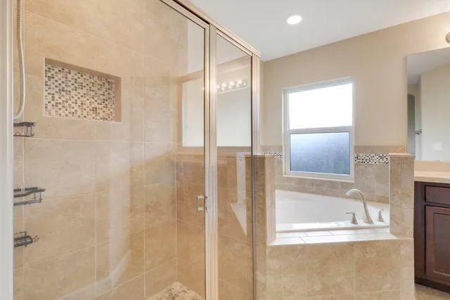 a bathroom with a glass shower door