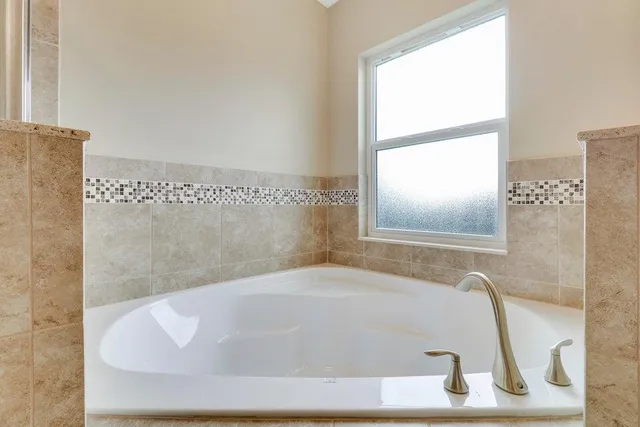a white bath tub sitting next to a window