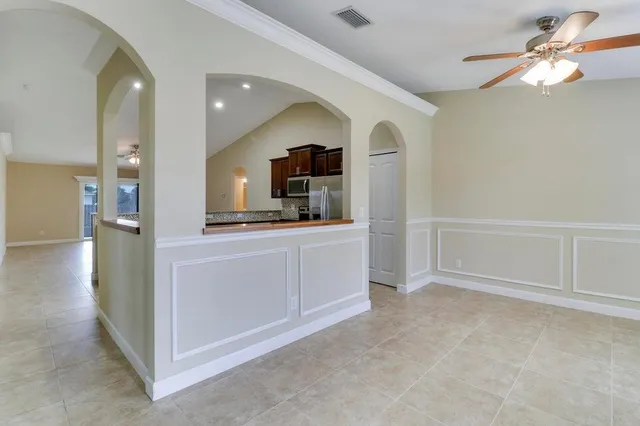 a view of a kitchen with a sink and a refrigerator
