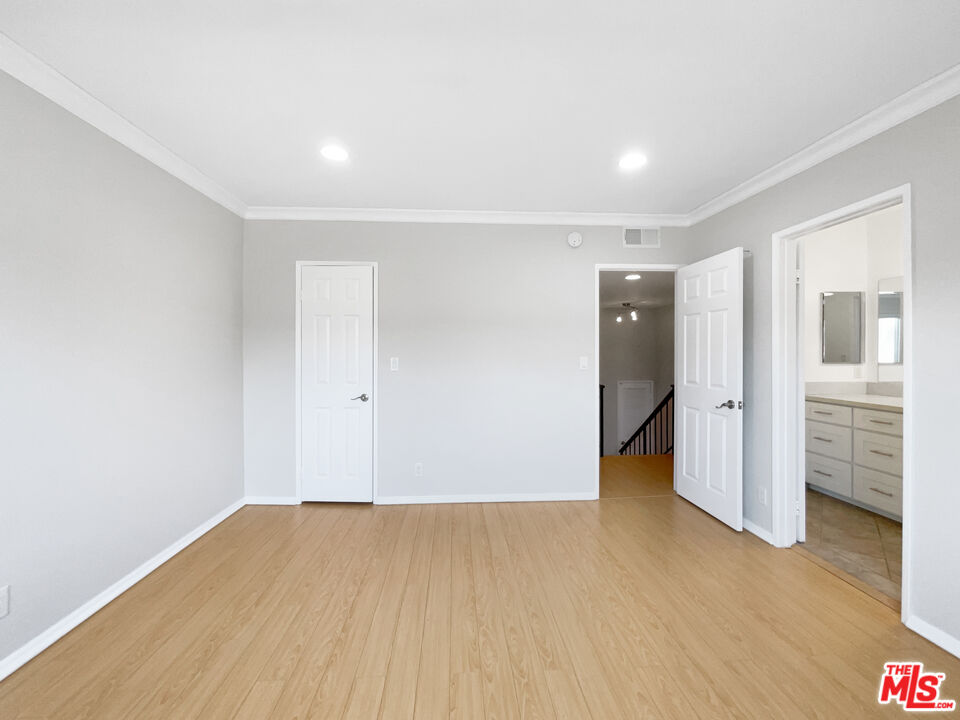 6864 Hatillo Avenue, Unit E Winnetka, CA 91306 - Photo 15 of 18 a view of empty room with wooden floor