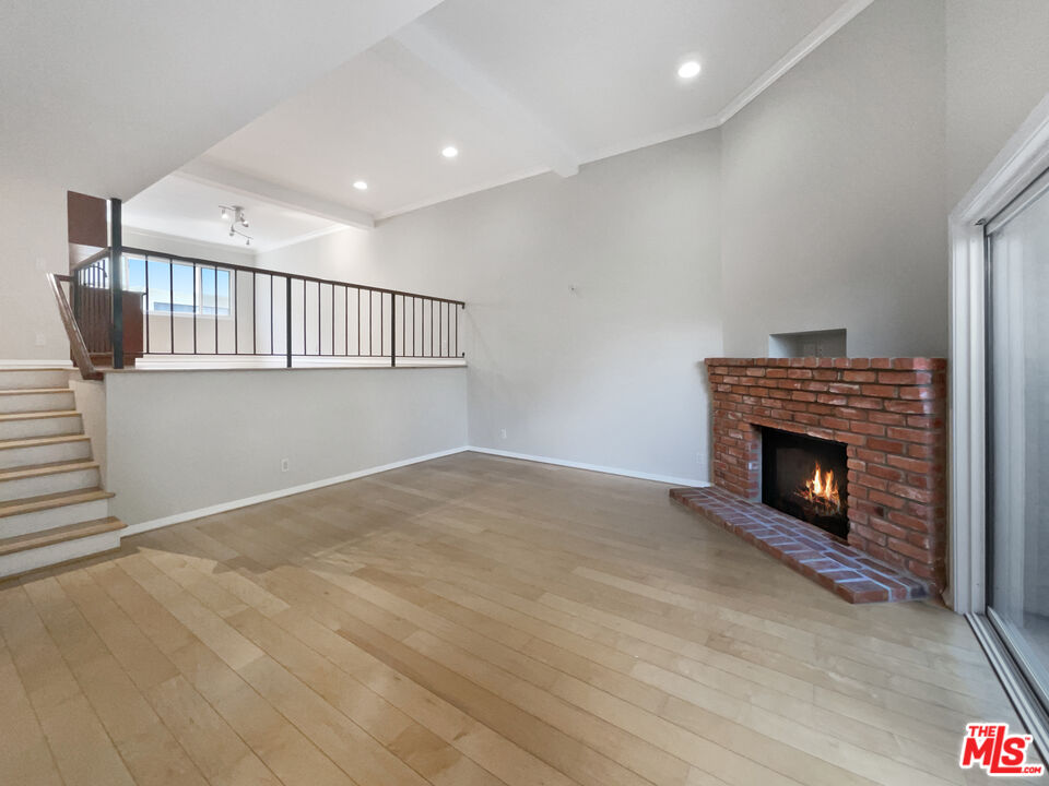 6864 Hatillo Avenue, Unit E Winnetka, CA 91306 - Photo 6 of 18 a view of an empty room with a fireplace