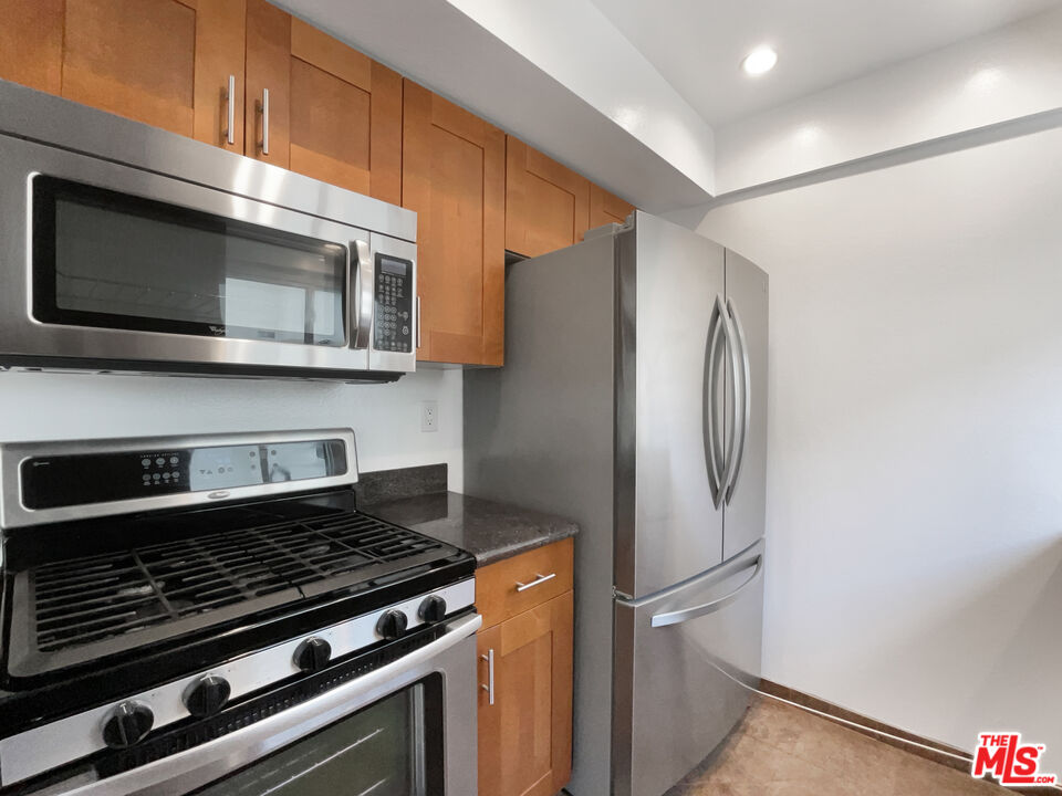 6864 Hatillo Avenue, Unit E Winnetka, CA 91306 - Photo 10 of 18 a metallic refrigerator freezer sitting inside of a kitchen