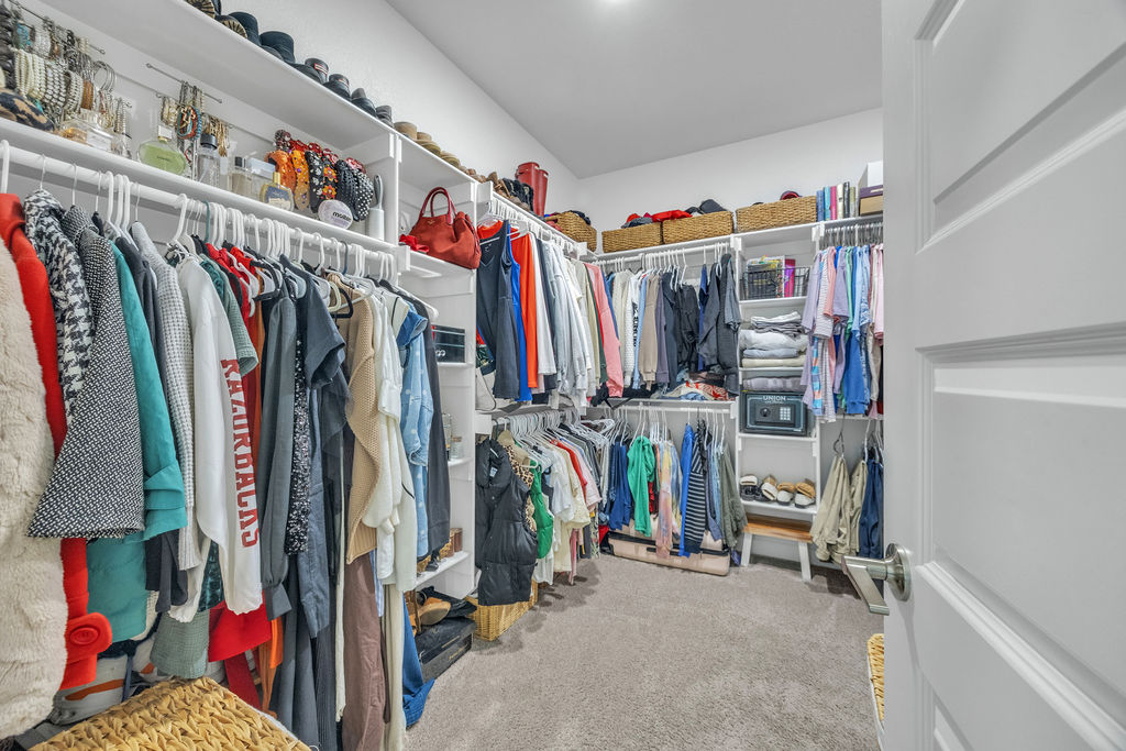 418 Casella Street Springdale, AR 72762 - Photo 19 of 34 Expansive walk-in closet featuring white shelving, multiple hanging rods, and built-in storage