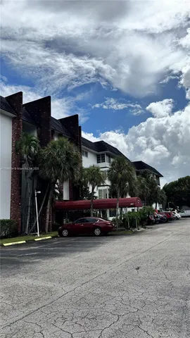 a view of house with car parked in front of house