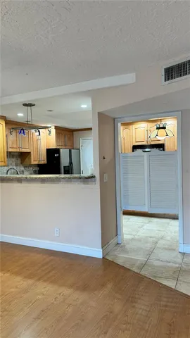 a view of a kitchen with a refrigerator