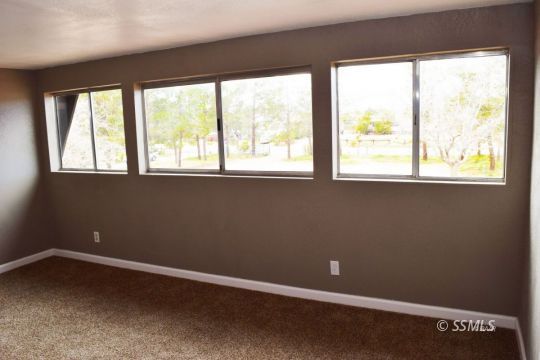 1130 South Guam Street Ridgecrest, CA 93555 - Photo 8 of 12 a view of an empty room with a window