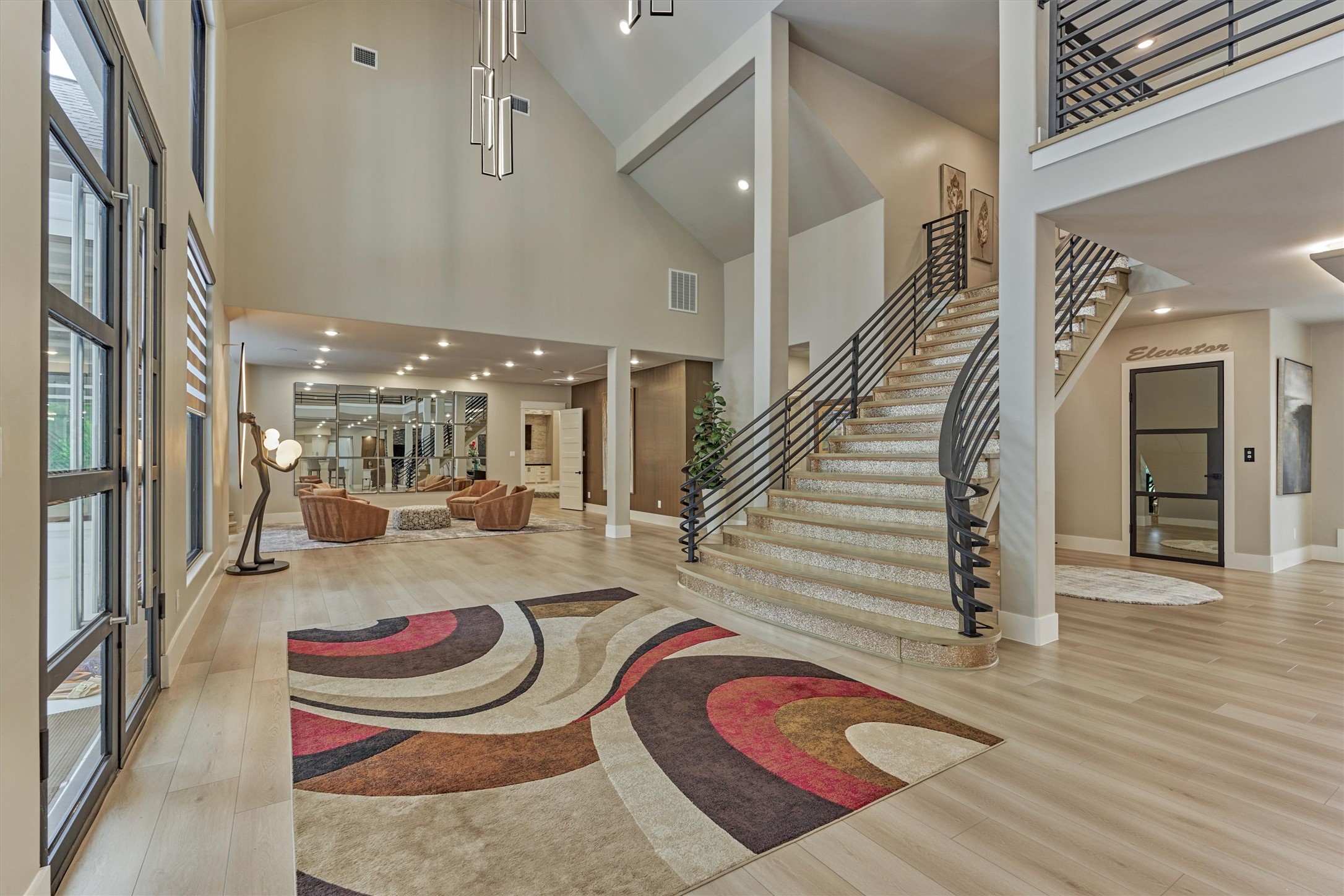 1907 Woerner Road Houston, TX 77090 - Photo 4 of 50 The striking foyer, highlighted by soaring ceilings, opens to beautifully connected living spaces that blend seamlessly together, creating an elegant atmosphere with neutral tones and effortless flow.