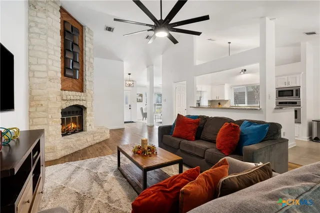 a living room with furniture fireplace and a flat screen tv