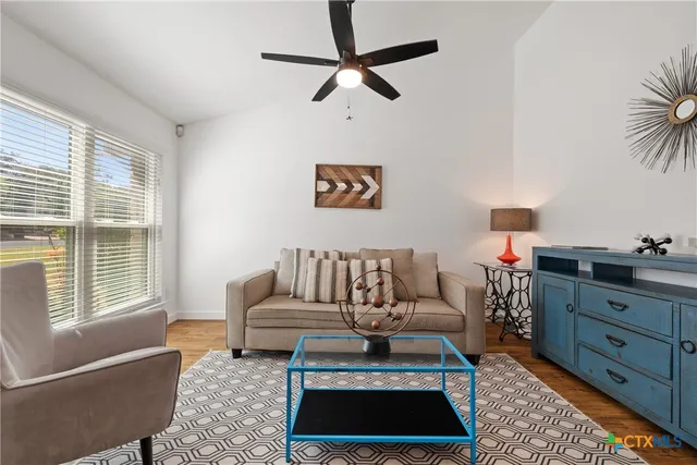 a living room with furniture rug and window