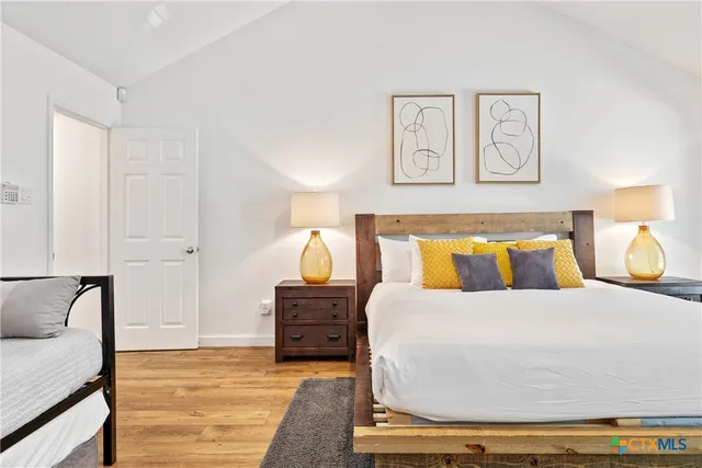 a bedroom with a bed and with furniture