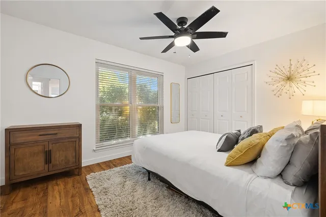 a bedroom with a large bed and a chandelier