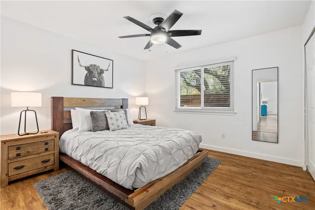 a bedroom with bed and a window