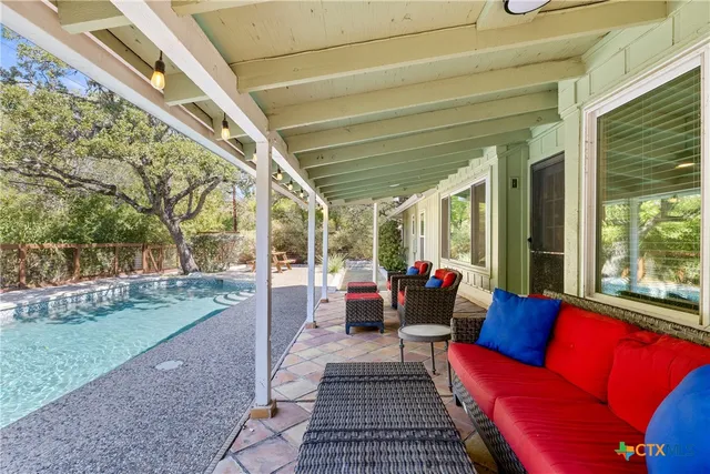 a view of a patio with couches and pool