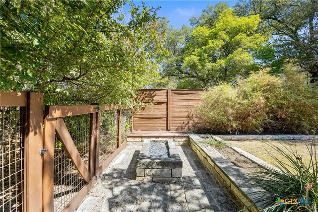 a view of balcony with wooden floor and fence