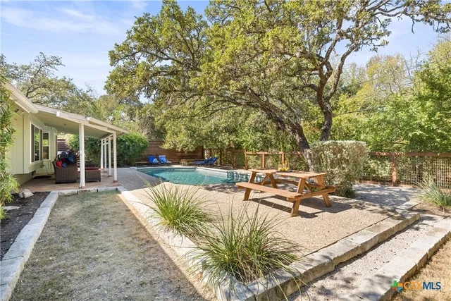 a view of a house with backyard and sitting area