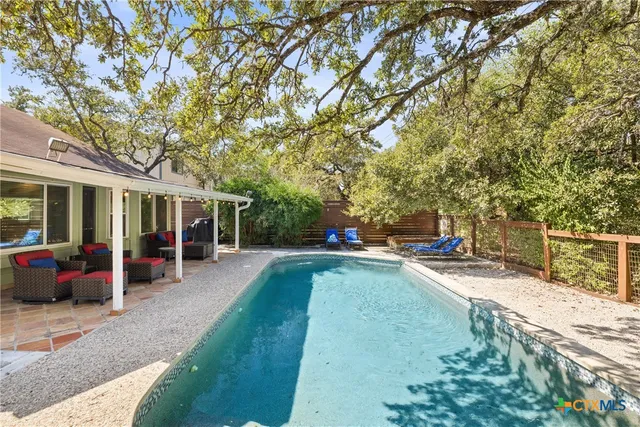 a view of a house with backyard porch and sitting area