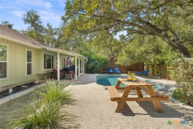 a view of a house with backyard porch and sitting area