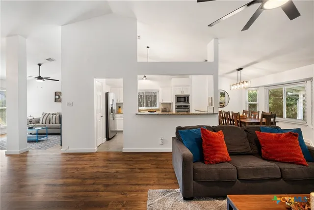 a living room with furniture and kitchen view