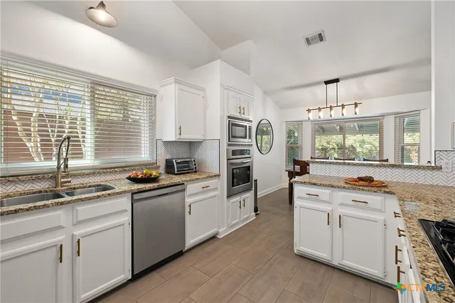 a kitchen that has a sink and a stove