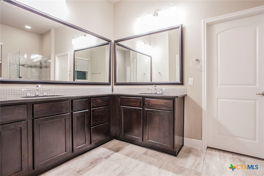 549 Wills Point Way Belton, TX 76513 - Photo 14 of 31 a bathroom with a granite countertop sink and a mirror