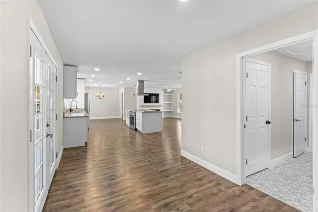 a view of open kitchen with wooden floor and electronic appliances
