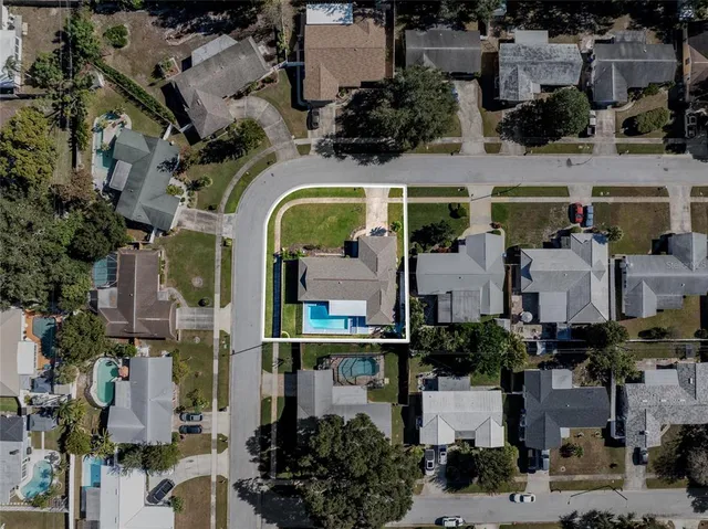 an aerial view of a house with a garden and swimming pool