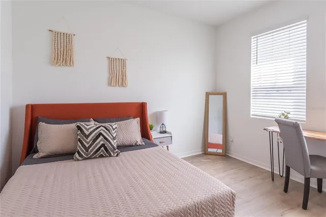 a bedroom with a bed and chair