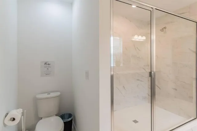 a bathroom with a toilet and a shower