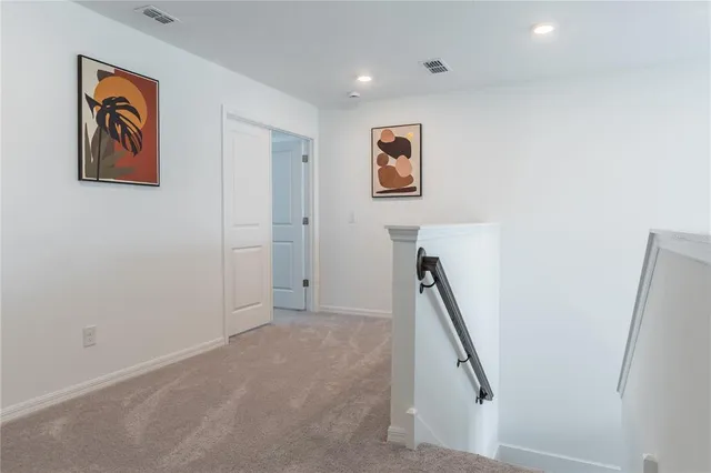 a view of a hallway with stairs
