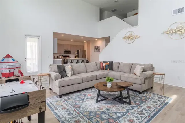 a living room with furniture and a wooden floor