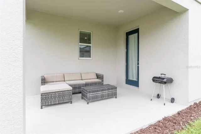 a living room with couches and a night stand