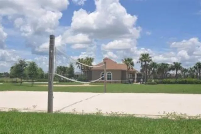 a view of a park and a large trees